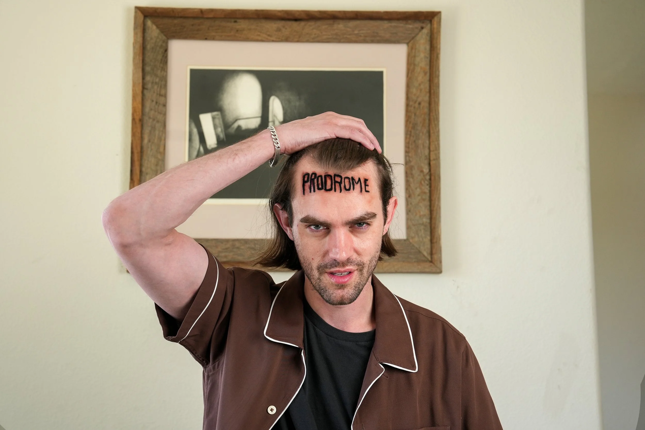 Jason Snow revealing the Prodrome mark on his forehead