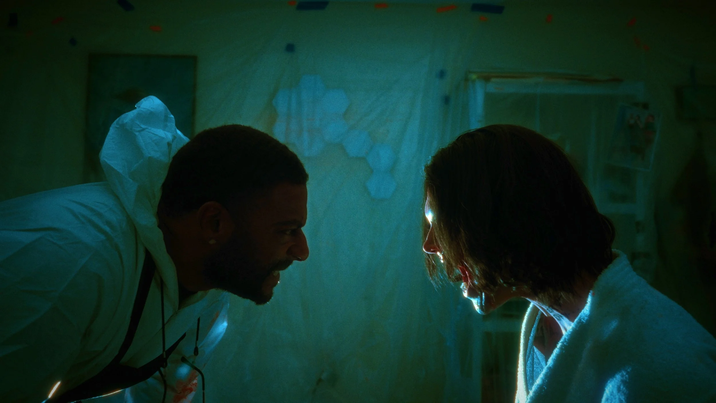 Characters facing an obscured figure in a dim room